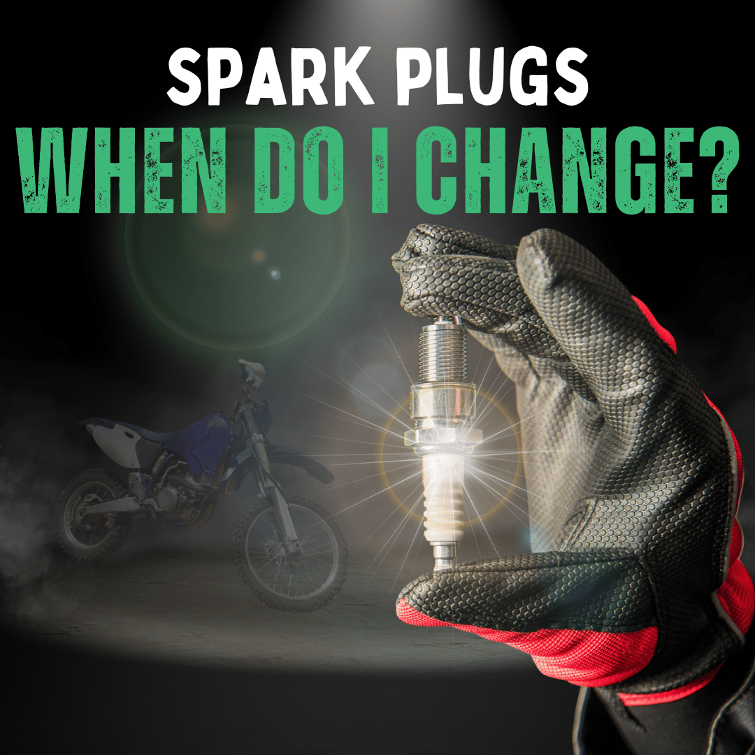 a picture of a hand holding up a spark plug