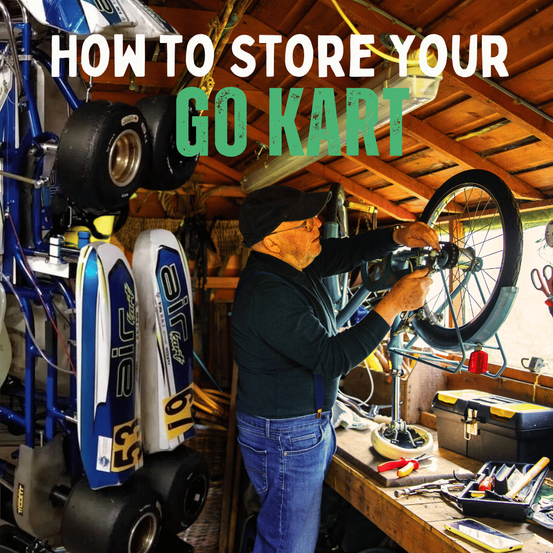 A man fixing his bike in a shed with go karts standing behind him