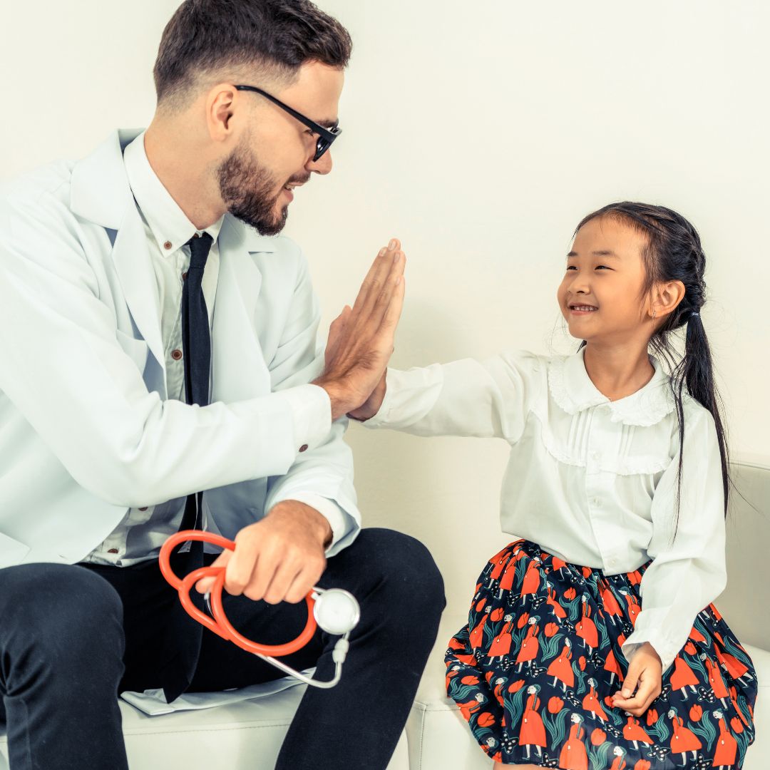 Asian child hi five with doctor