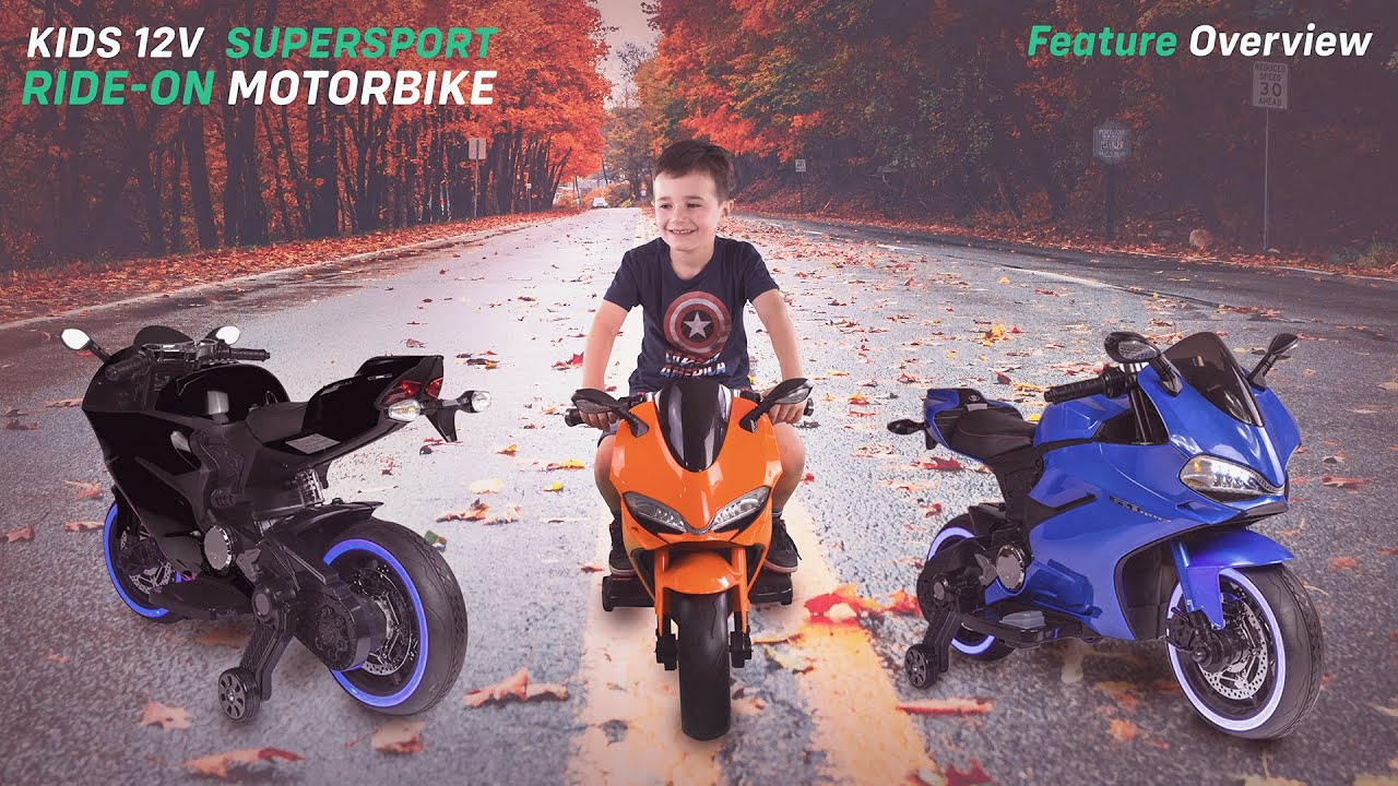 young boy sitting on ride on Ducati Style Motorbike