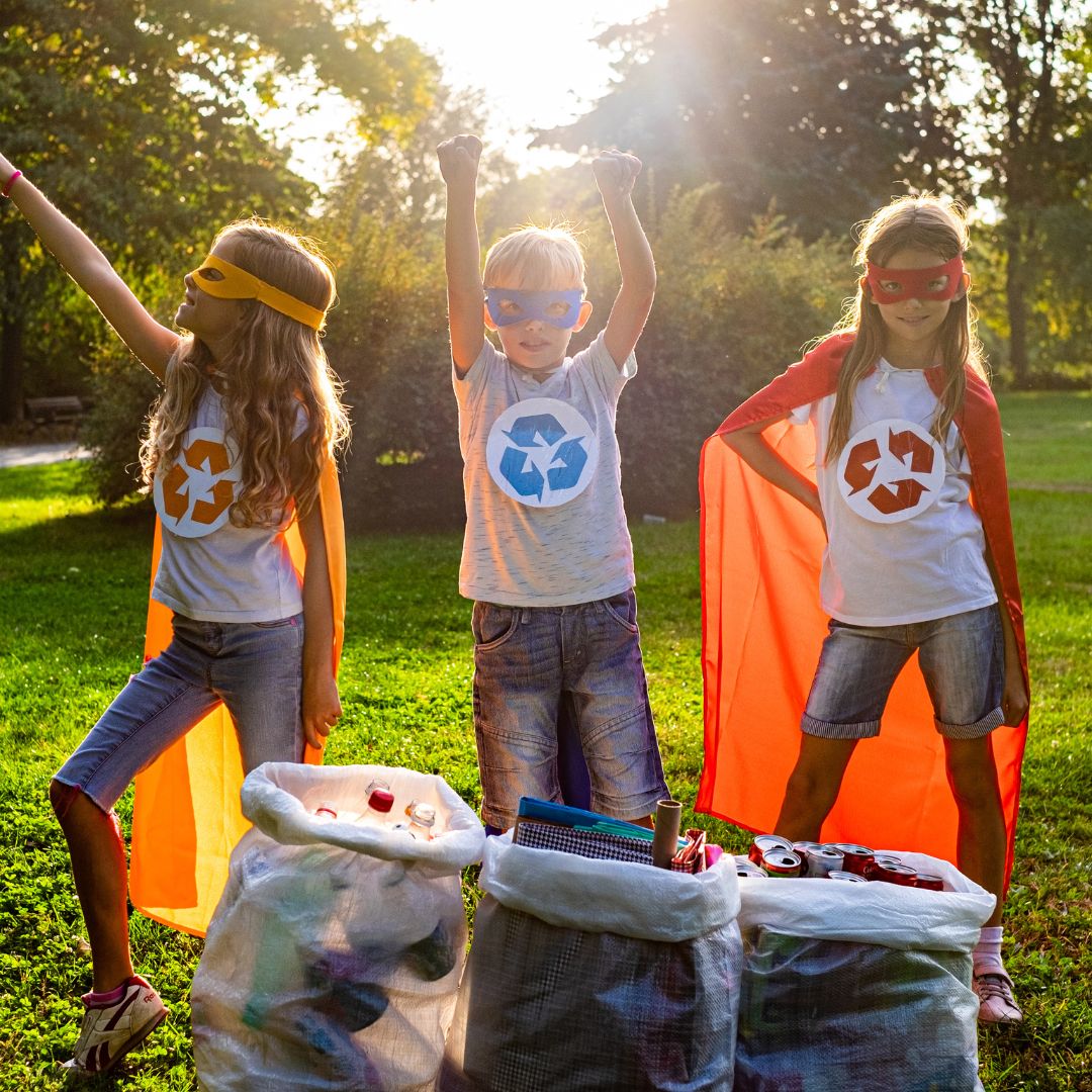 3 kids with recycling images on their t shirts
