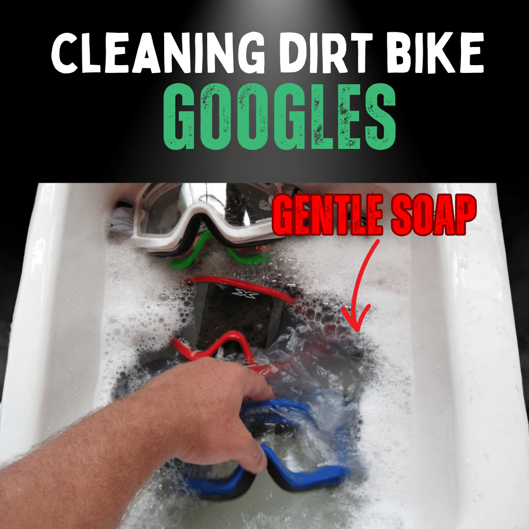 someone cleaning motorbike googles in sink