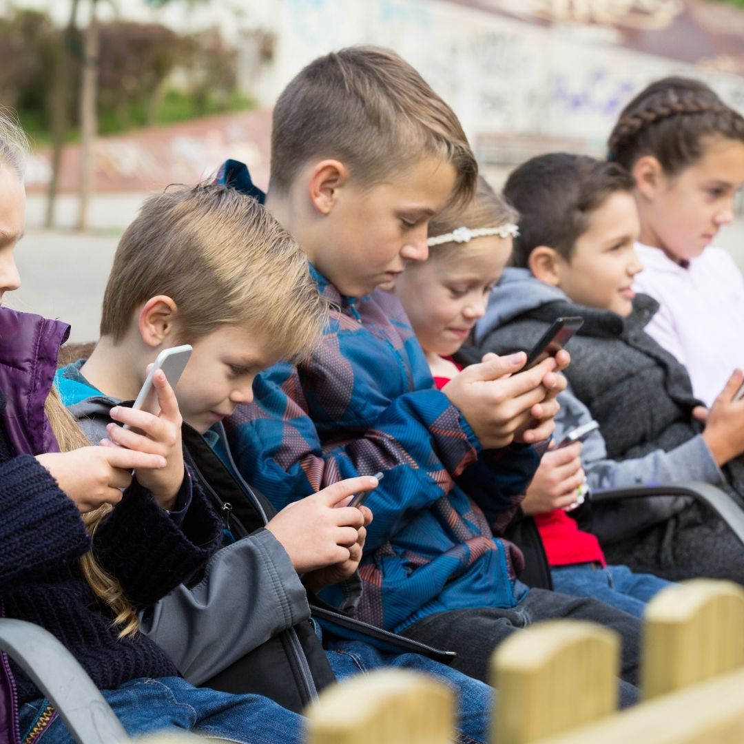 kids on their phone looking at social media