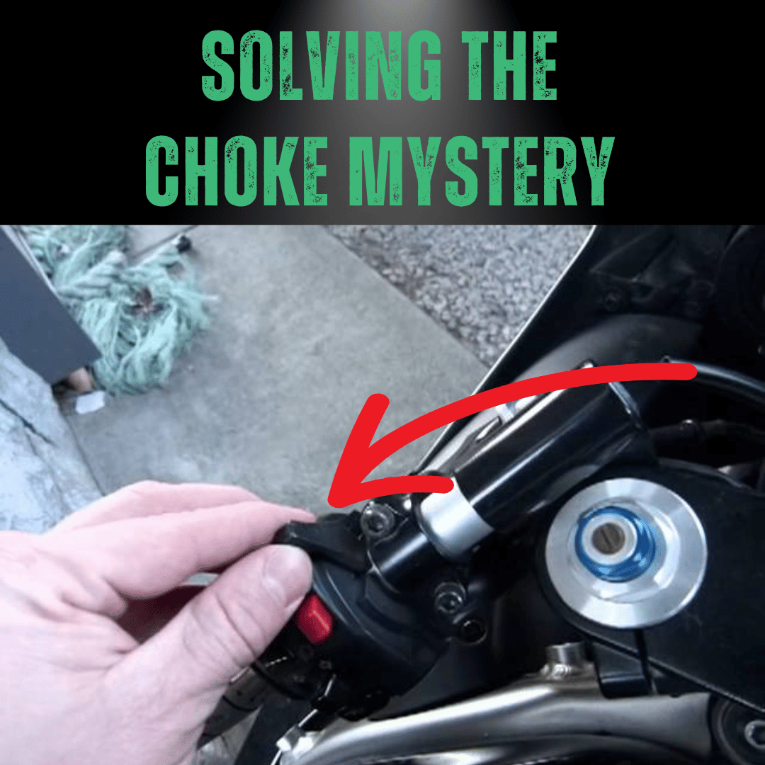 A hand about to adjust a motorbike choke