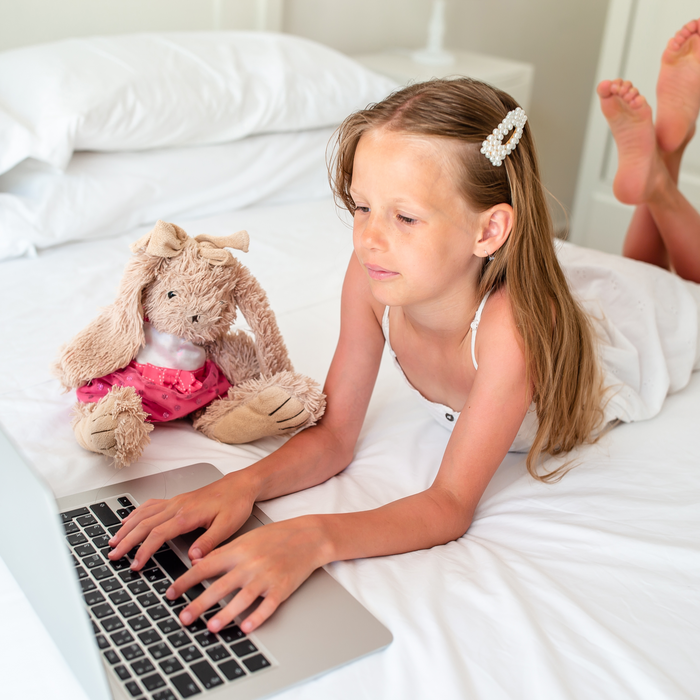 young girl doing homework on her computer