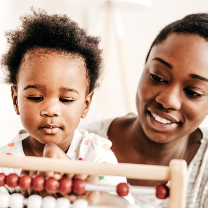 a black mum with child  - education play