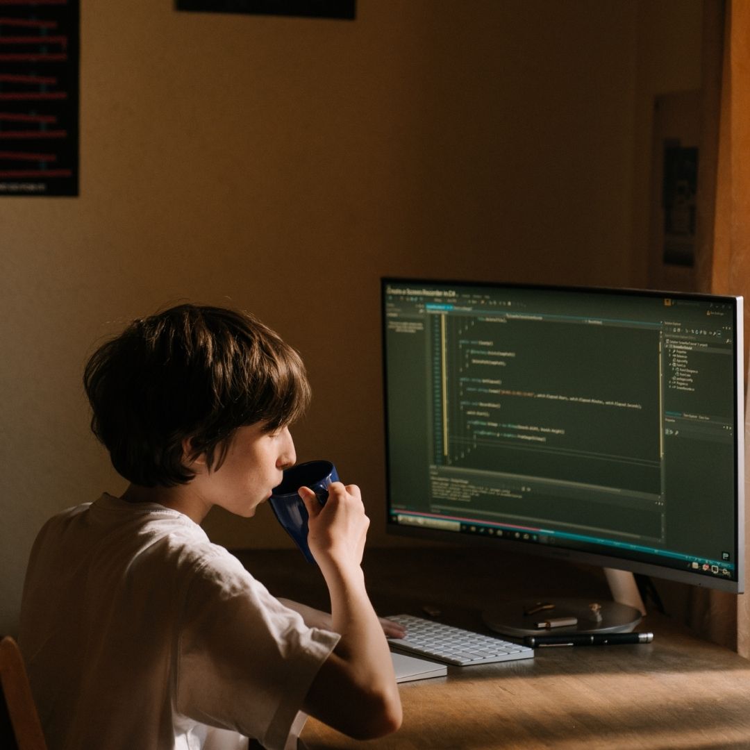 a kid doing some programming on computer