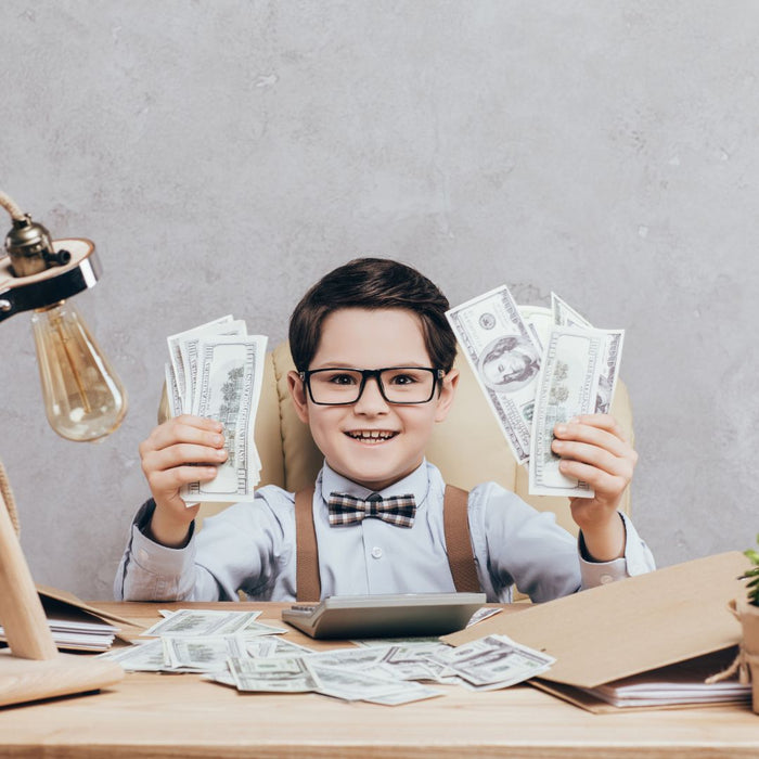 a kid with glasses holding up money