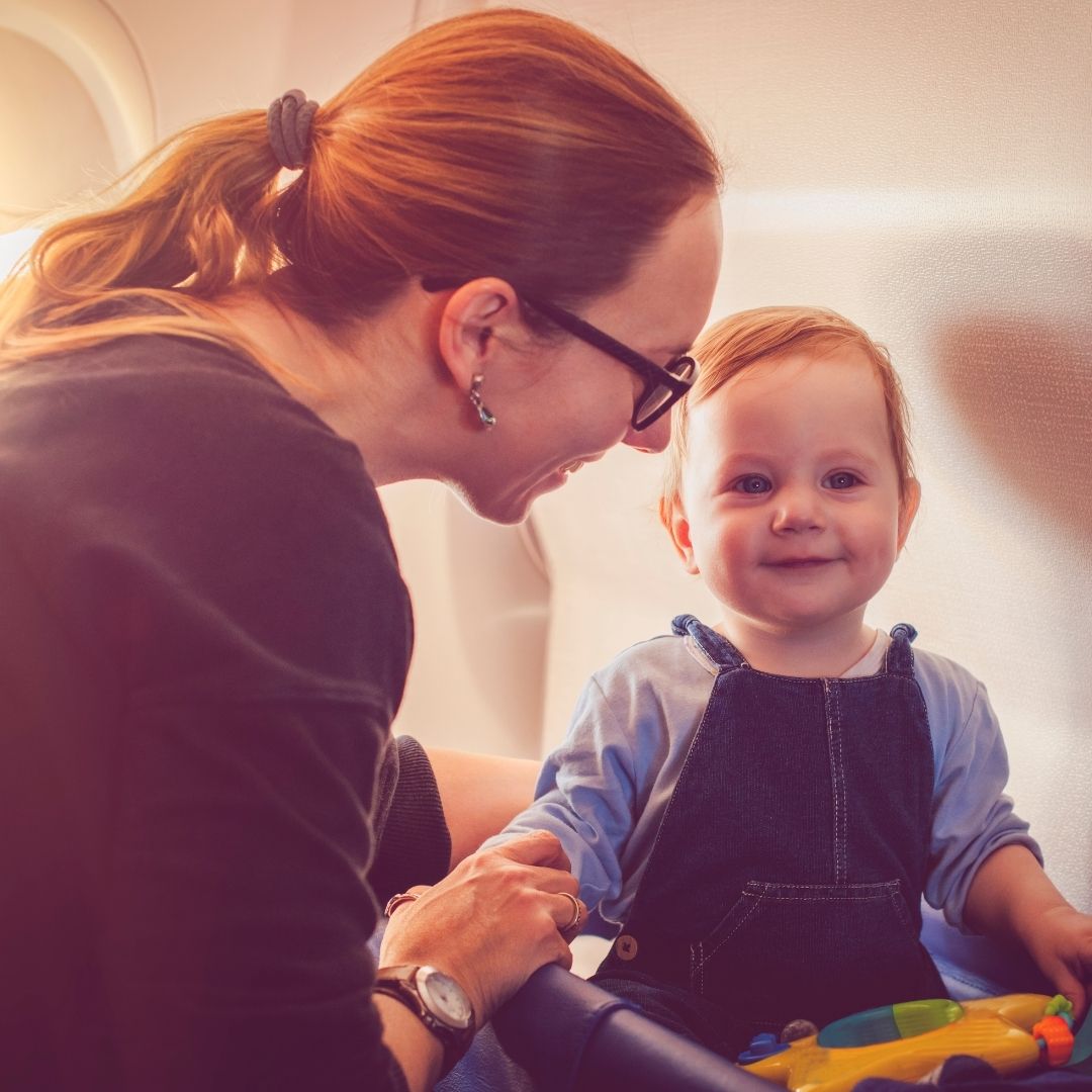 a mother and baby travelling on a plane