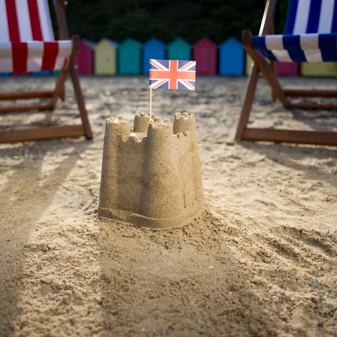 a  union flag on a sandcastle on a British Beach