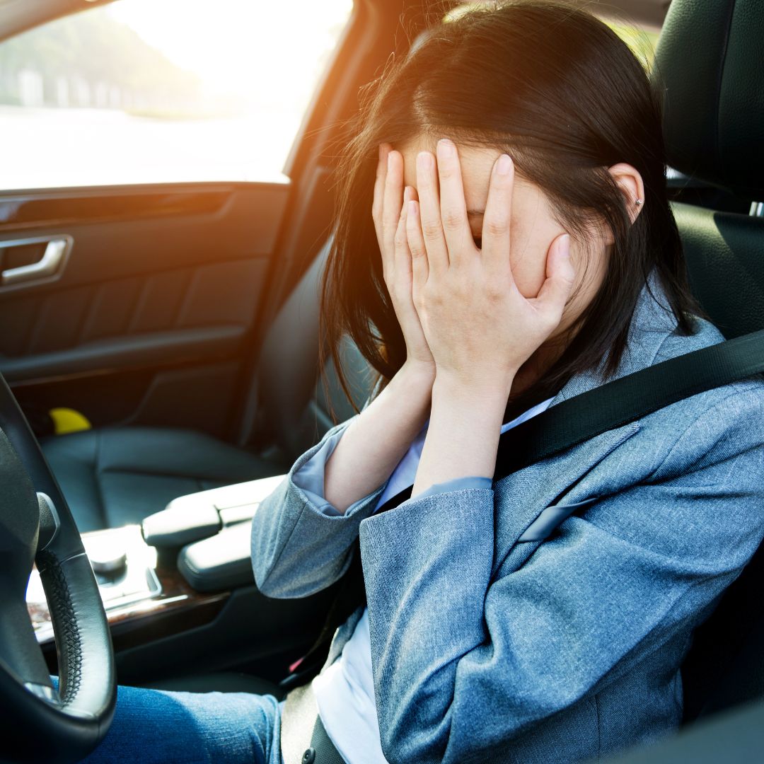 a young woman who is sad in a car rental