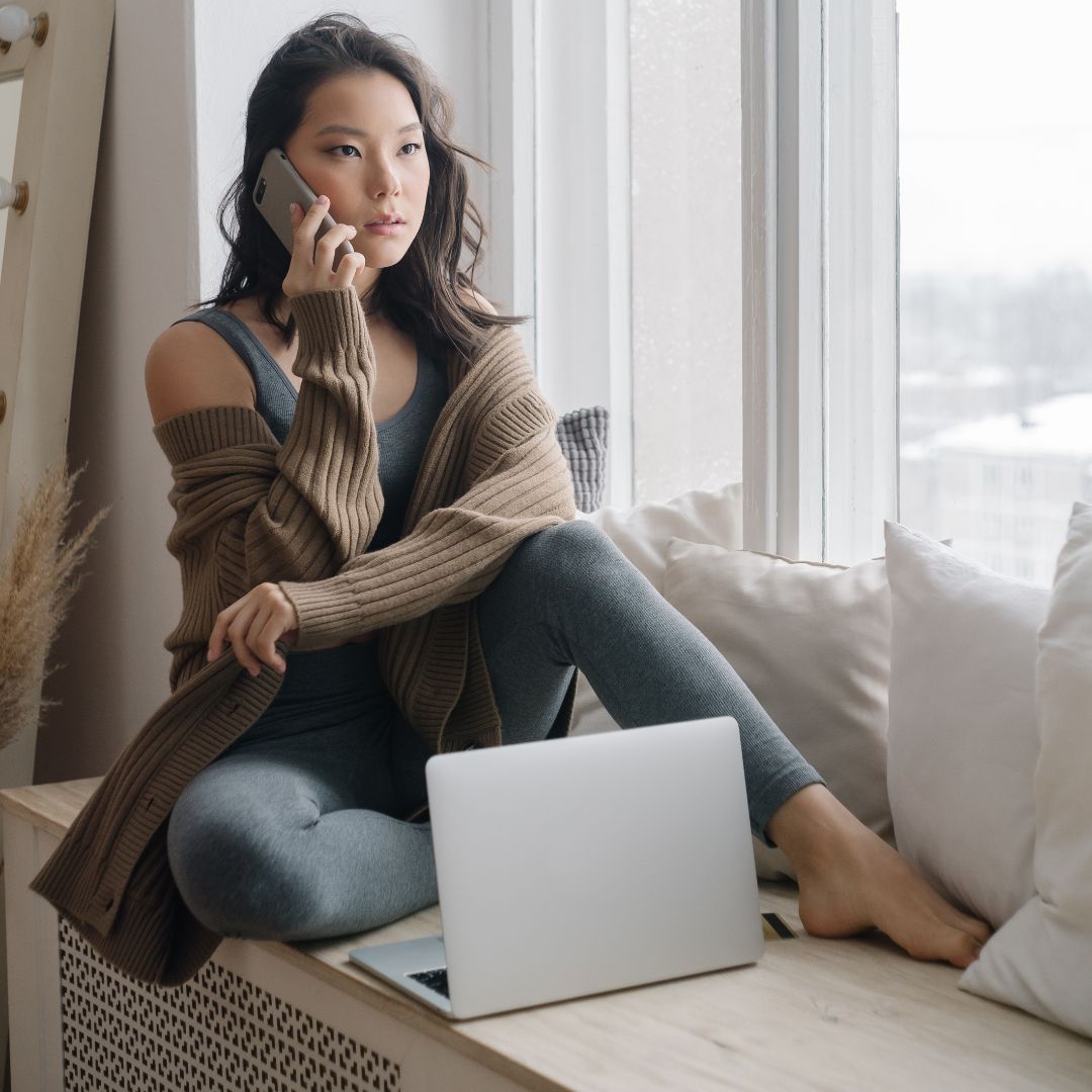 an asian woman talking on her mobile