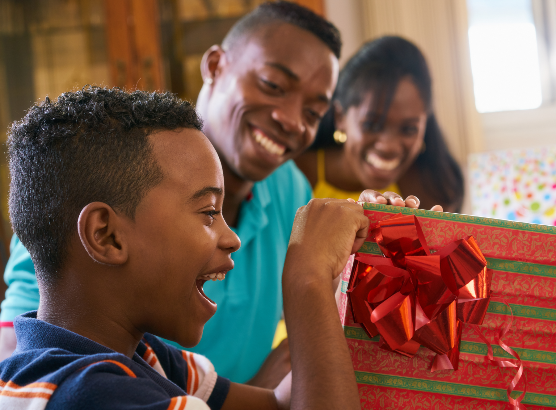 black child opening his present