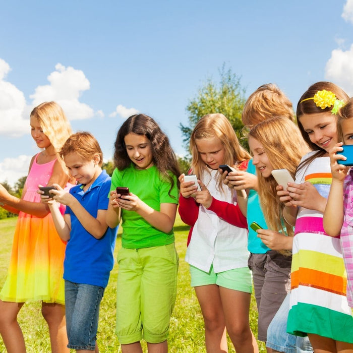 lots of kids looking at social media on their phones