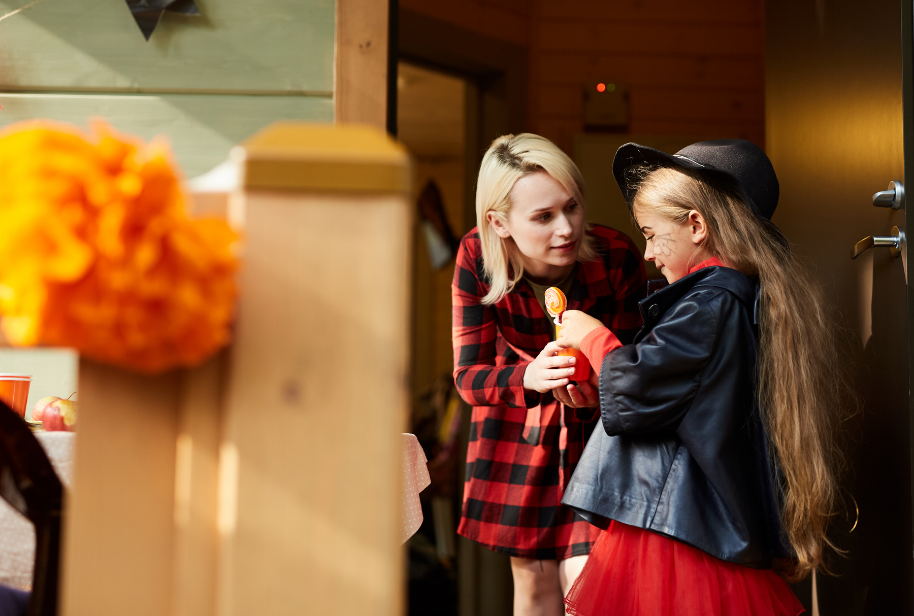 Mother giving her child a lollypop