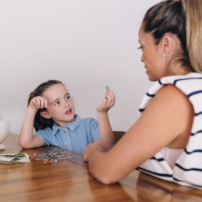 mother teaching daughter about money