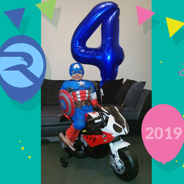 child in Captain America superhero sitting on BMW S1000RR ride on motorbike