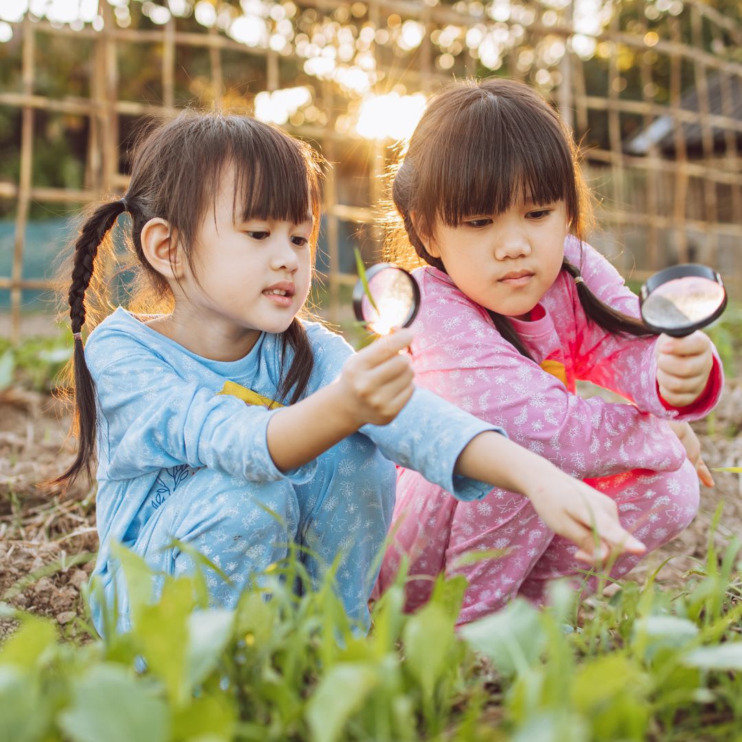 two asian girls playing in their garden