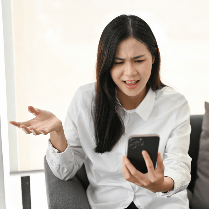 unhappy asian woman on phone