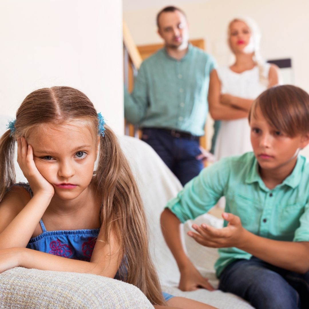 unhappy child with her parents