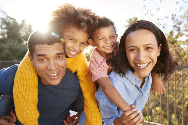 Mixed race couple with their kids in the sun