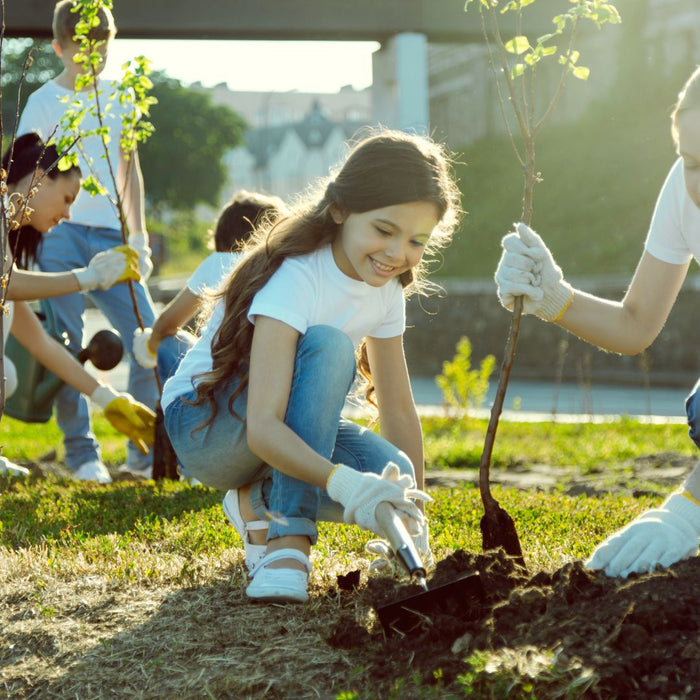 young children volunteering by gardening