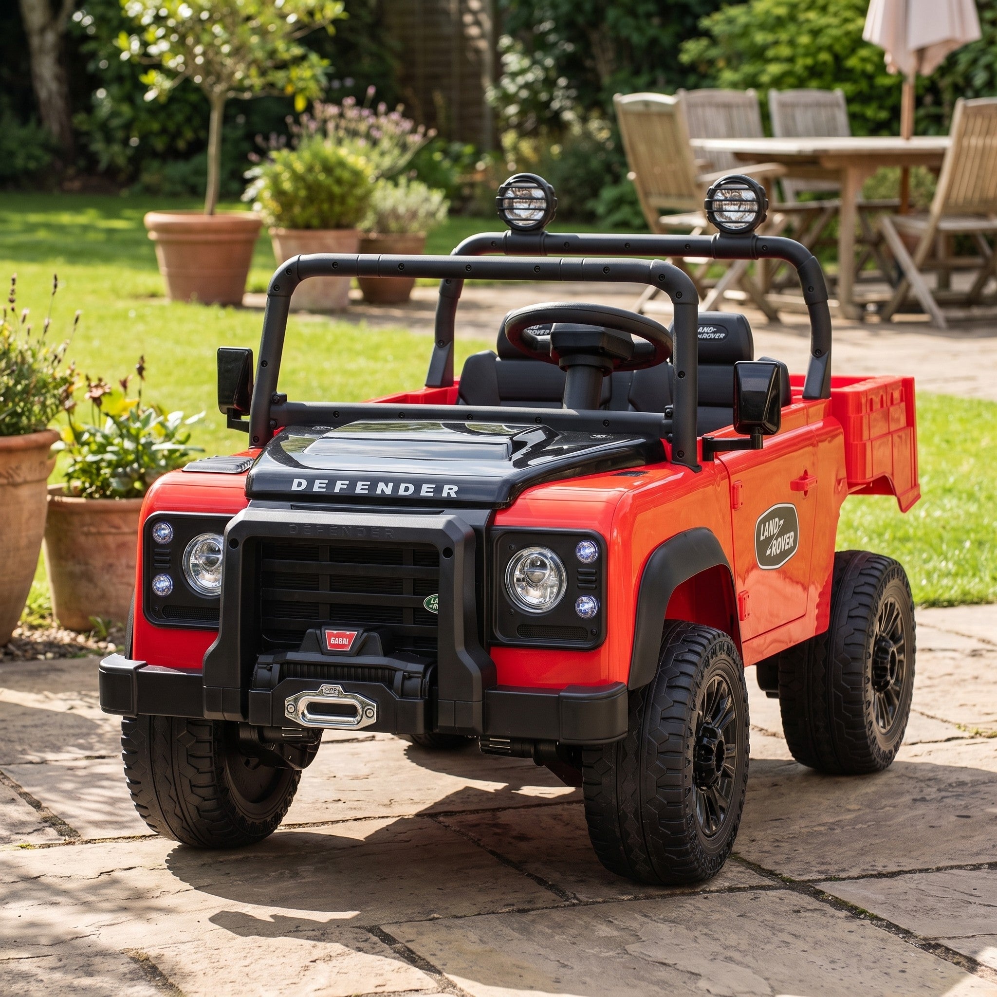 08-licensed-land-rover-defender-90-24v-kids-electric-ride-on-car-red-garden-lifestyle.jpg